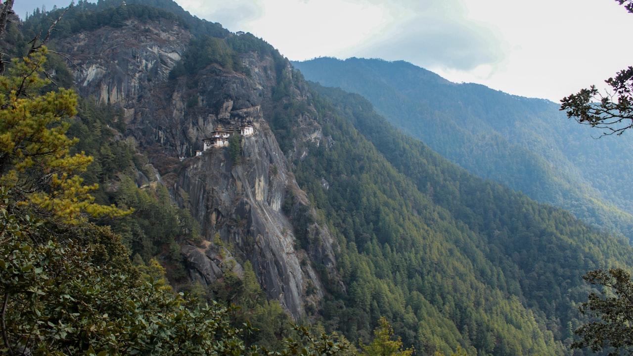 Forested Himalayan ridges receding into mist