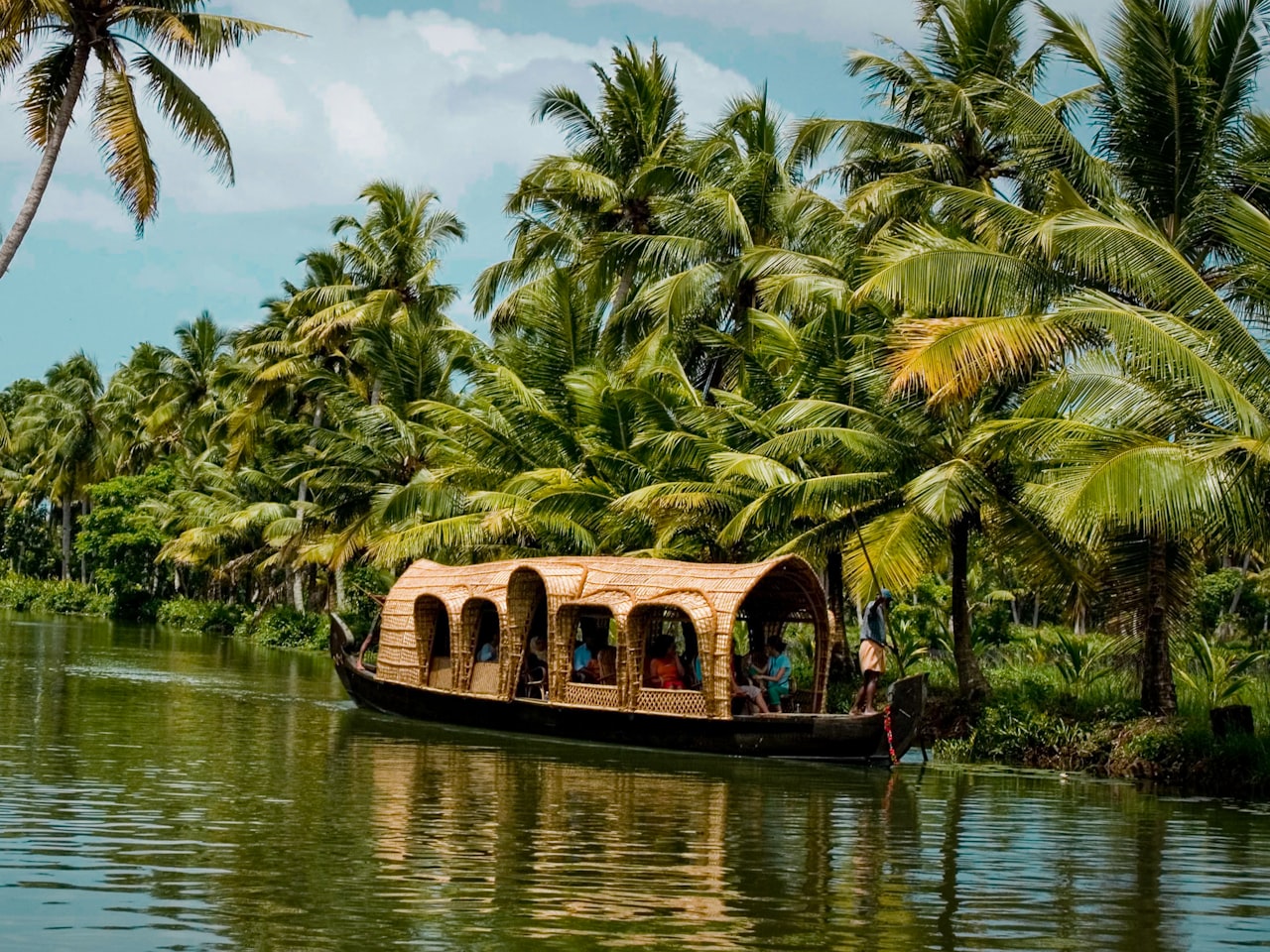 A wooden boat on the palm-fringed Kerala backwaters, India