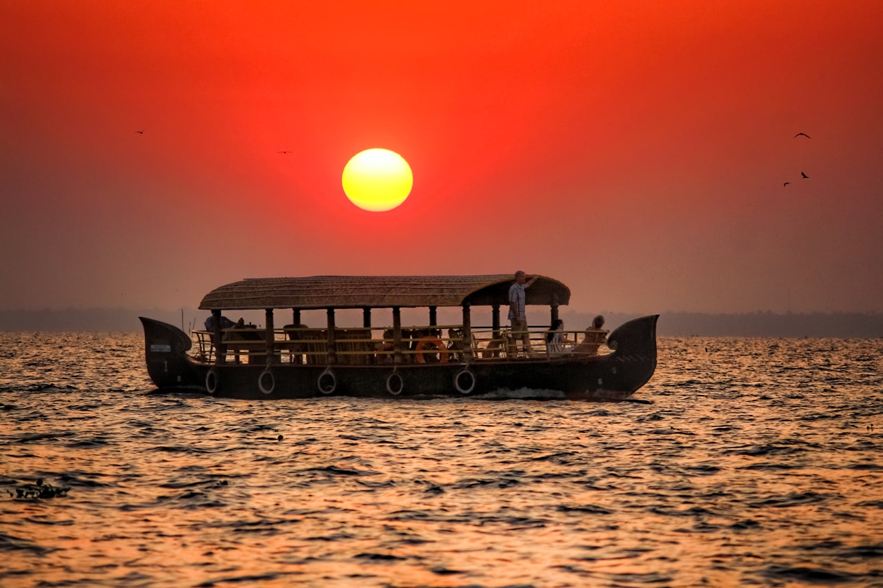 A boat on quiet water at sunset in Kerala, India