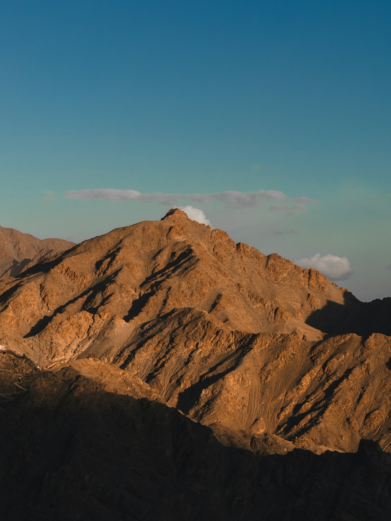 A whitewashed monastery above the mountains of Ladakh, India