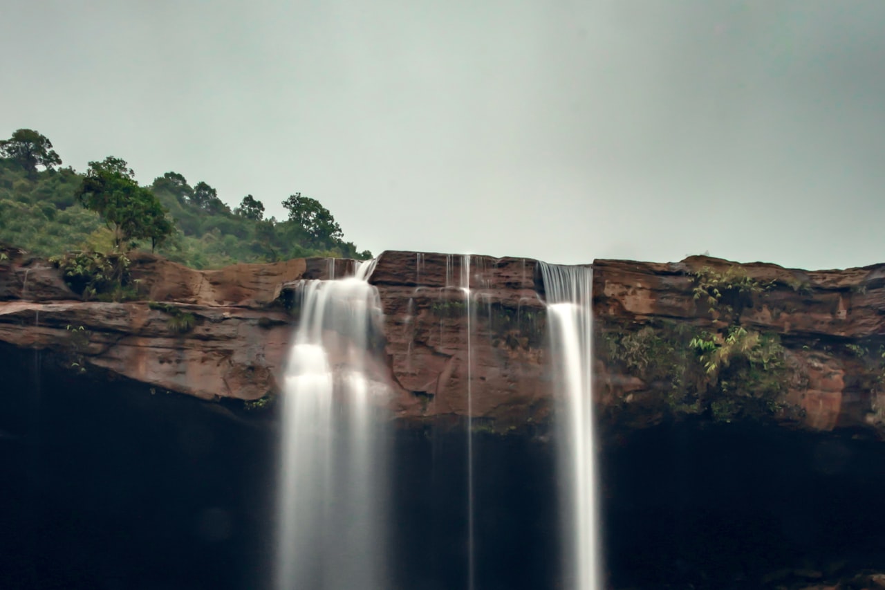 A waterfall dropping down a cliff face in Meghalaya, India