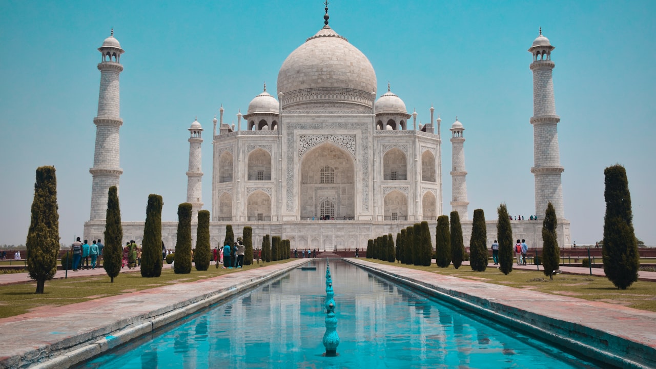 The Taj Mahal seen across its reflecting pool at dawn